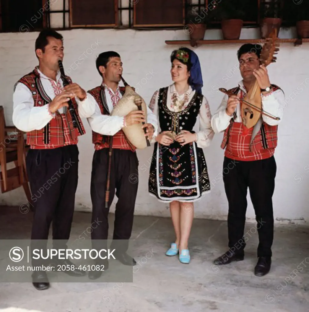 People standing wearing traditional costumes of Bulgaria