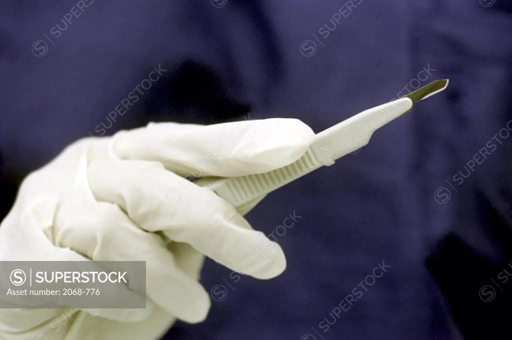 Close-up of a surgeon holding a scalpel