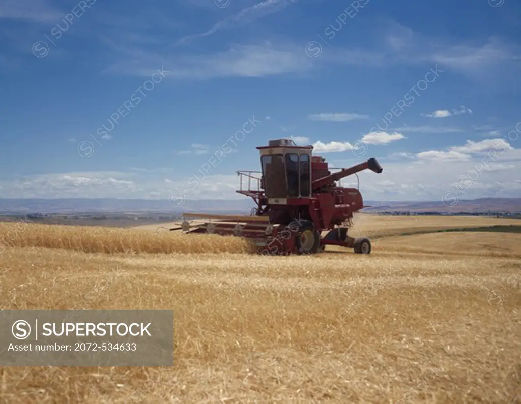 Combine harvesting barley in a field, Walla Walla, Washington State, USA