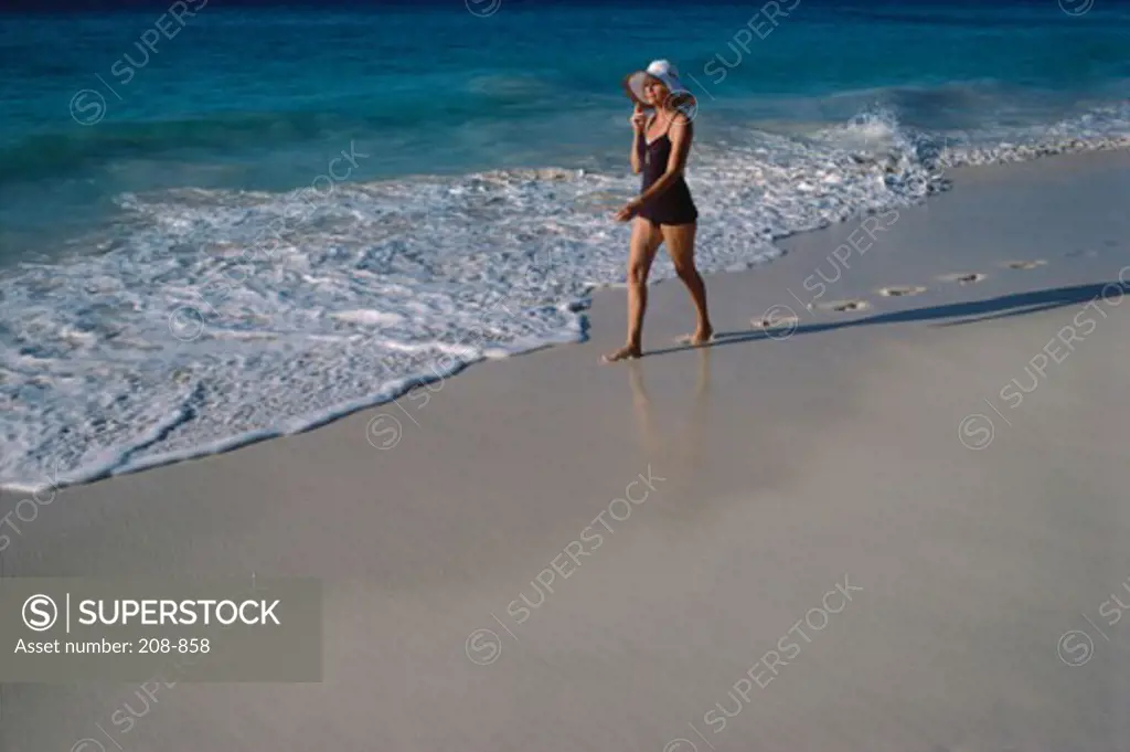 Mature woman strolling on the beach