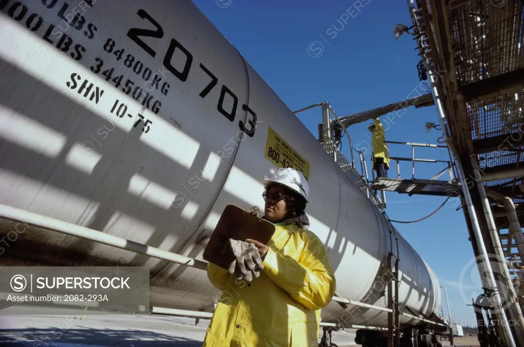 Chemical Workers inspecting and loading a tank of Molten Dimethyl Terephthalate