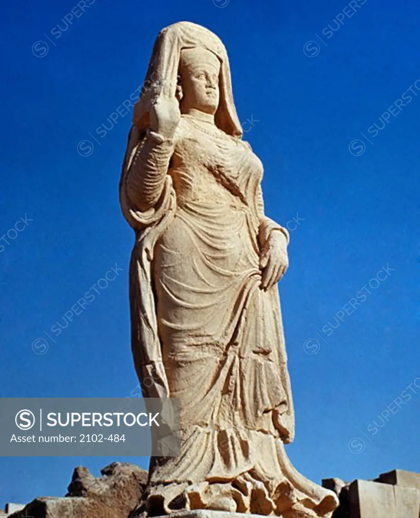 Iraq, Hatra, female stone sculpture against blue sky