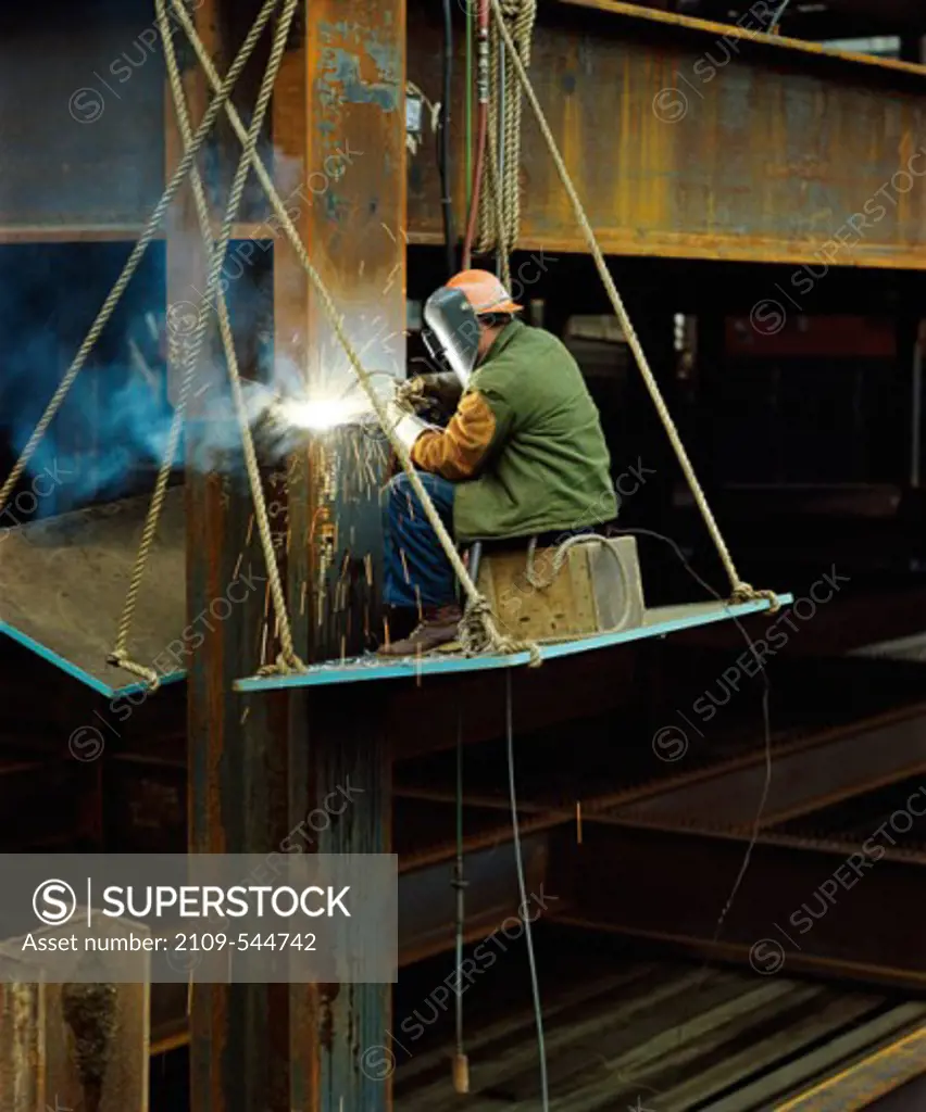 A welder on a platform welding, Portland, Oregon, USA