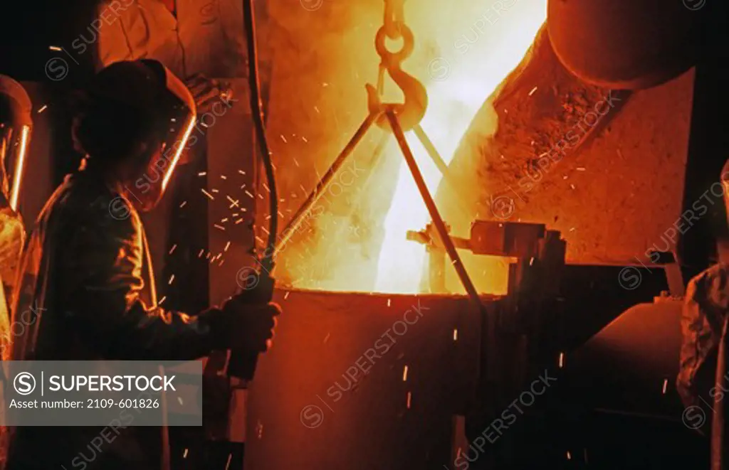 Worker pouring titanium alloy prior to casting