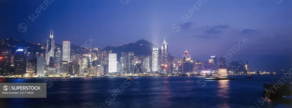Skyscrapers lit up at night, Victoria Harbor, Hong Kong, China