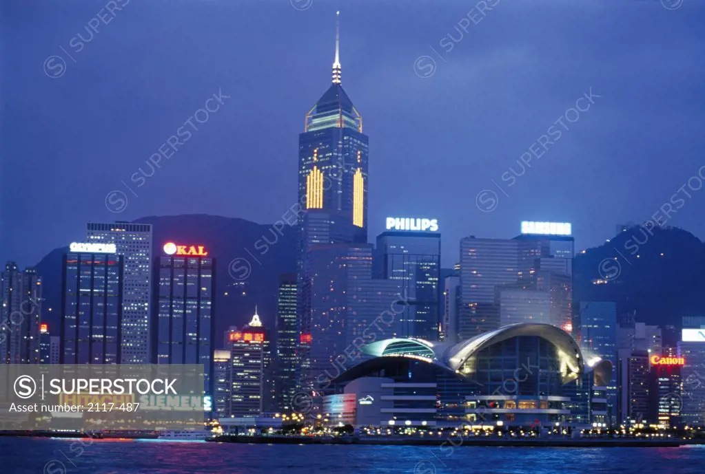 Skyscrapers lit up at night, Victoria Harbor, Hong Kong, China