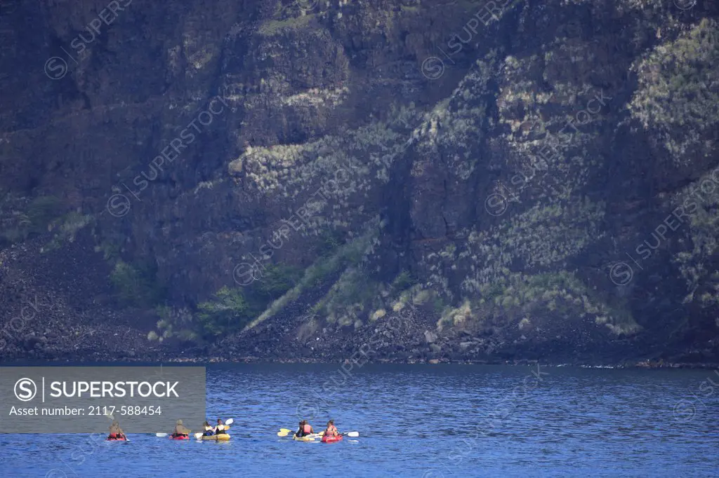 Hawaii, Kayakers in Kealakekua Bay with pali (cliff) in background