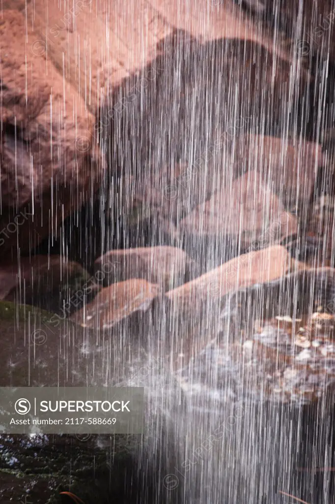 USA, Utah, Zion, Water cascades down over granite boulders in Zion National Park