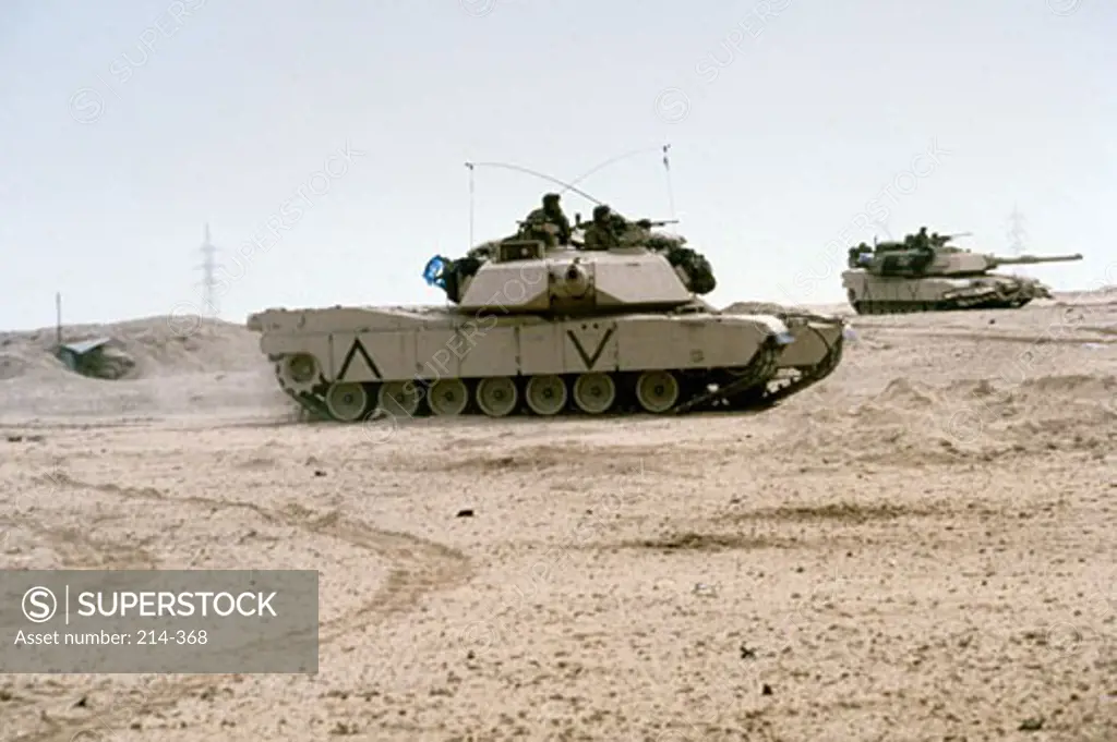 Kuwait: Two M-141 Abrams Main Battle Tanks Pass Through an Abandoned Iraqi Post During Ground Phase of Desert Storm