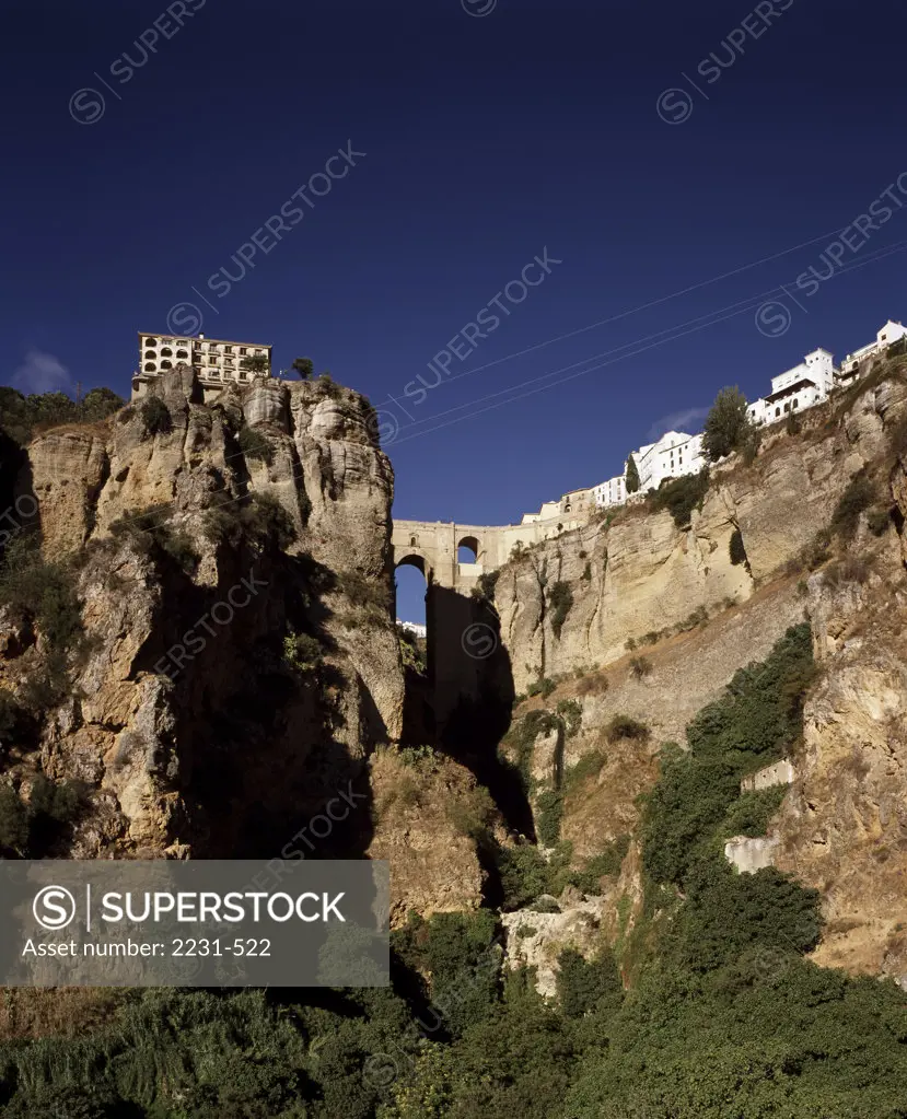 Low angle view of buildings on a cliff, Ronda, Malaga, Spain
