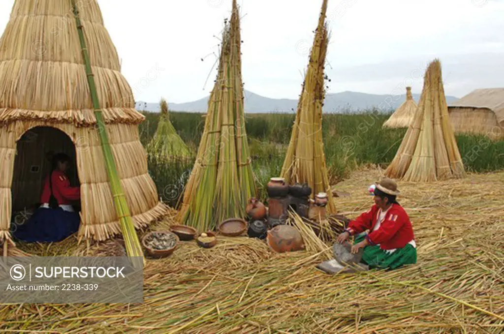 Tribal woman cooking food, Puno, Peru