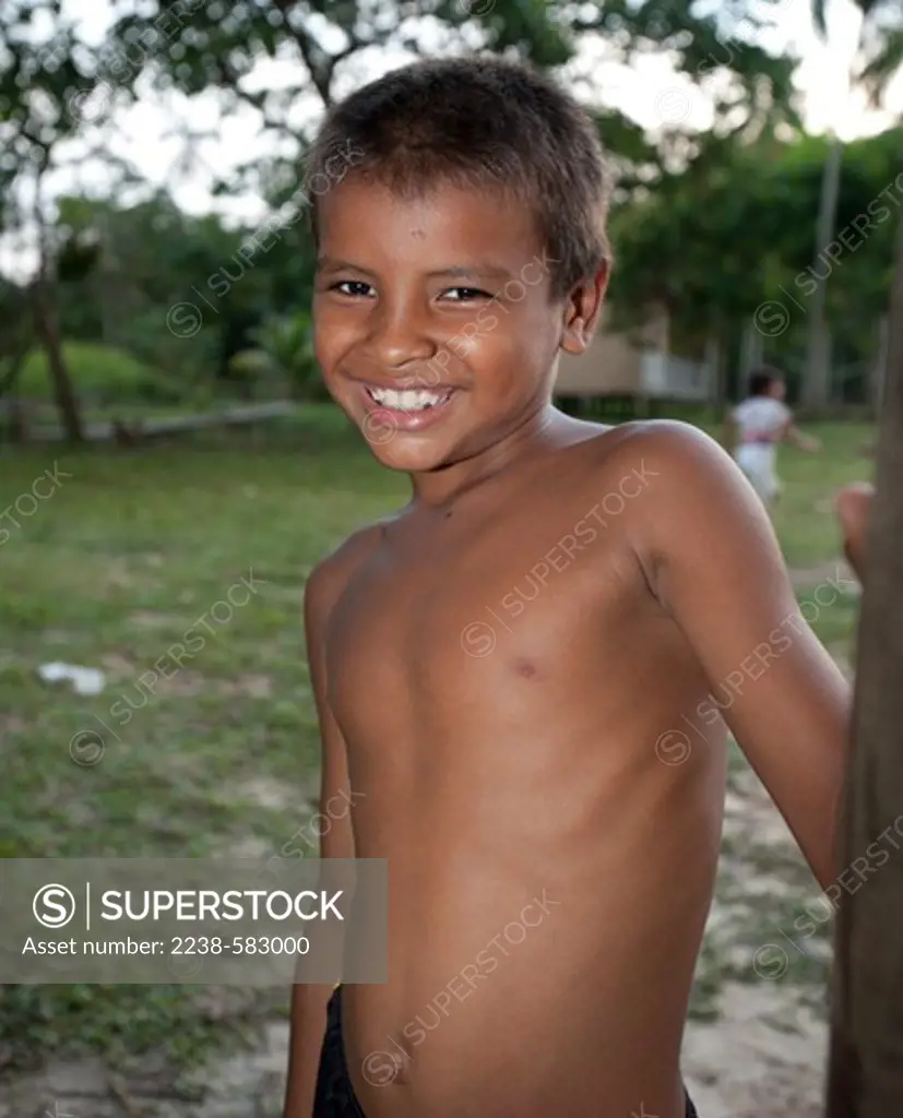 Village boy Henner 7 yrs, playing soccer. Ubim, Lago Amana, Amazonas, Brazil, 9-17-12