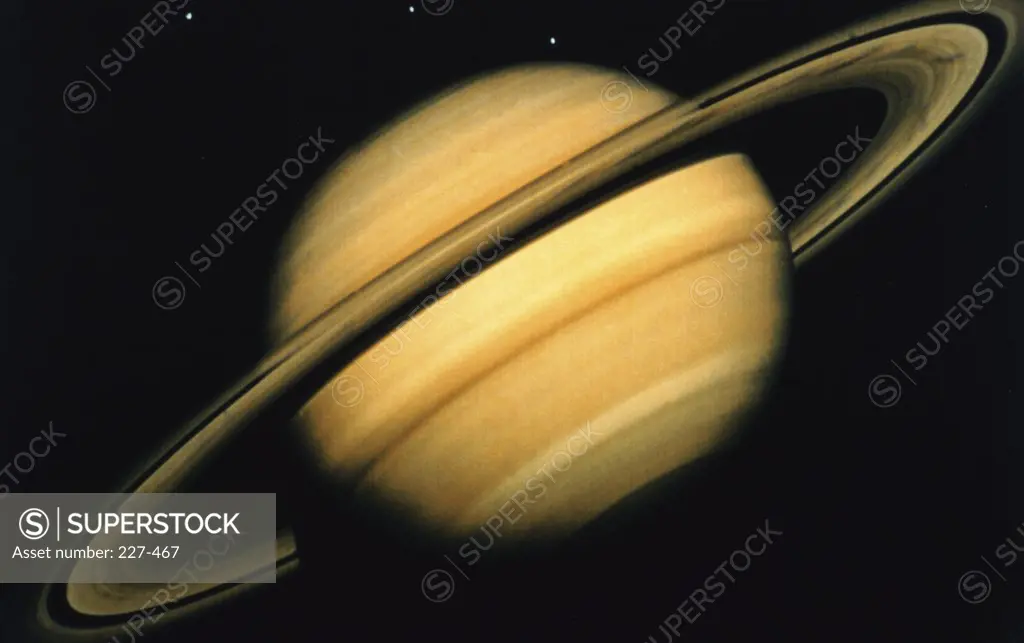 True Color Image of Saturn Taken by Voyager 2 (8/4/81). 3 of Saturn's Icy Moons are Seen (Tethys, Thea & Dione).