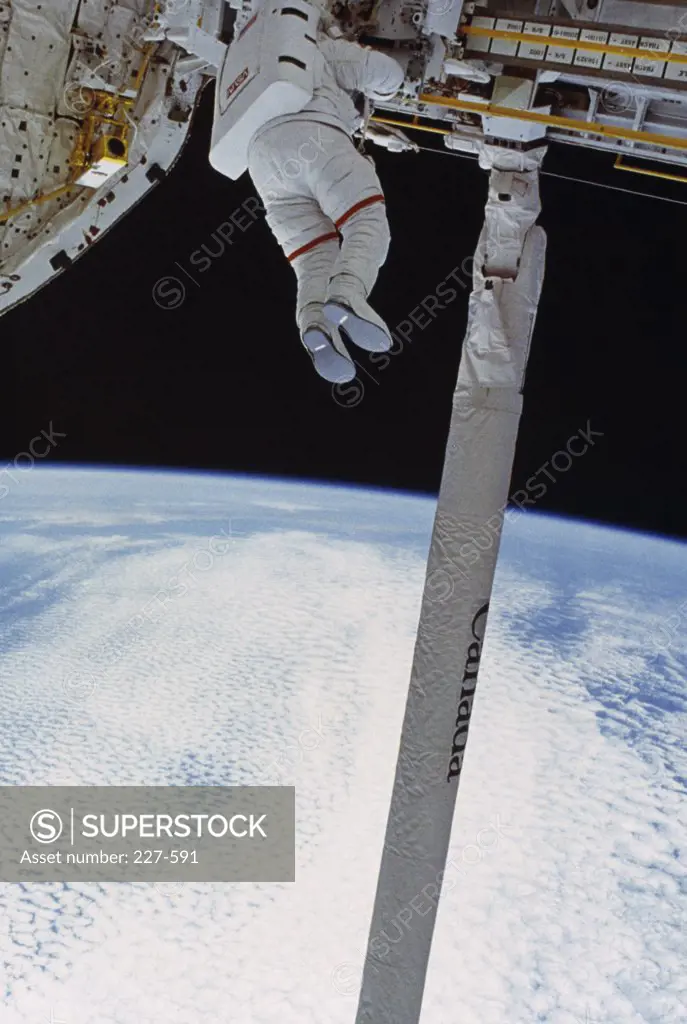 Jerry L. Ross Testing a Device Possible for Translation Aids on Space Station Freedom. (W/Remote Manipulator System-RMS)
