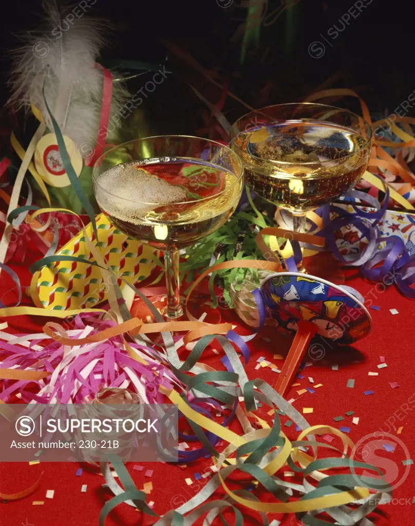 Close-up of streamers with two glasses of champagne