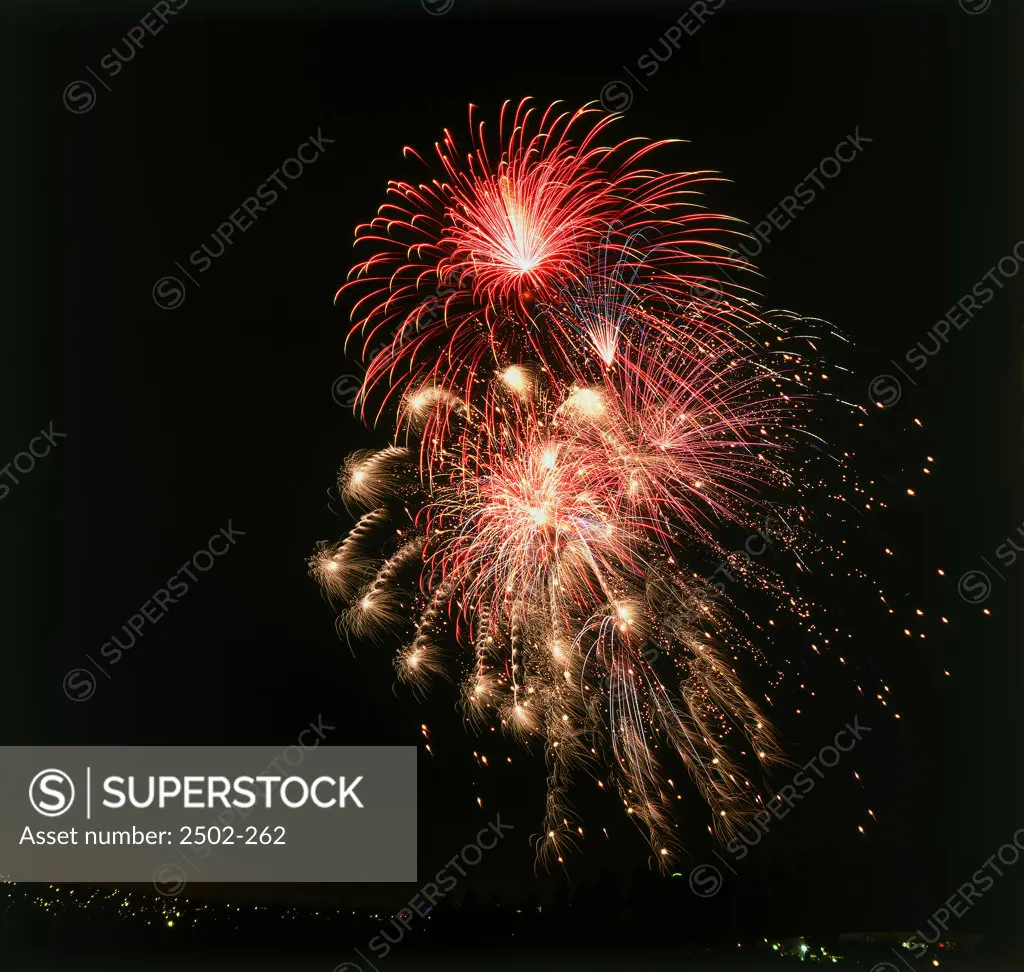 Low angle view of fireworks display at night in a city