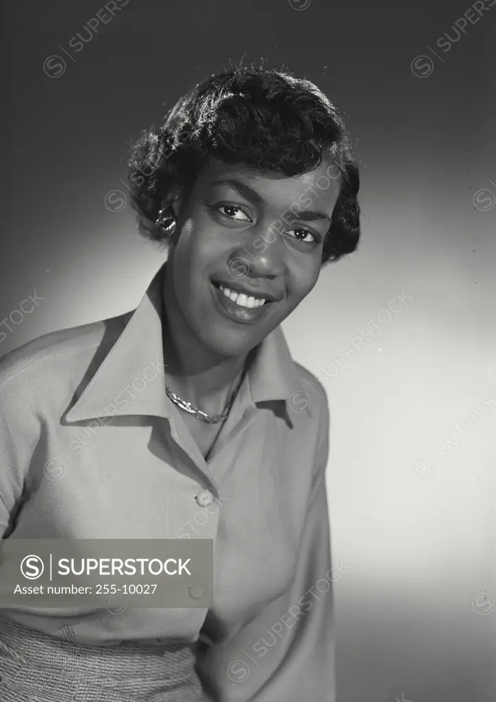 Vintage Photograph. Smiling woman wearing blouse and necklace looking at camera