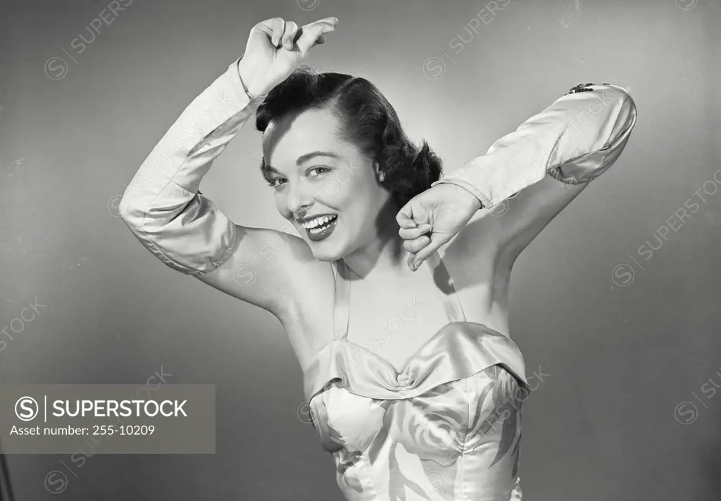Vintage photograph. Portrait of a young woman dancing looking at camera
