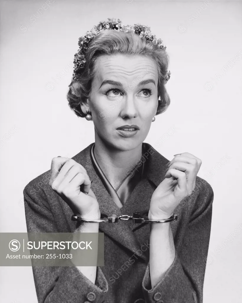 Close-up of a mid adult woman wearing handcuffs