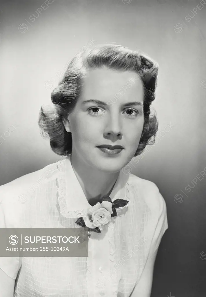 Woman wearing white blouse with flower brooch