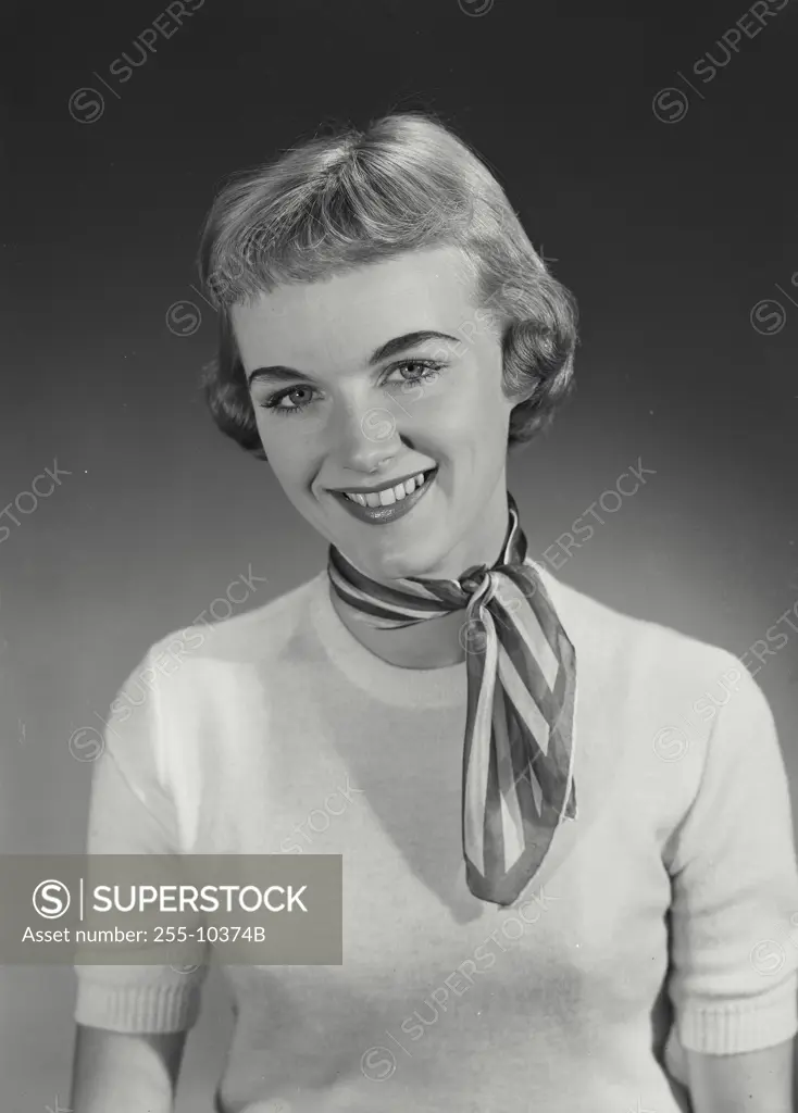 Vintage Photograph. Woman with short hair in sweater looking at camera. Frame 2