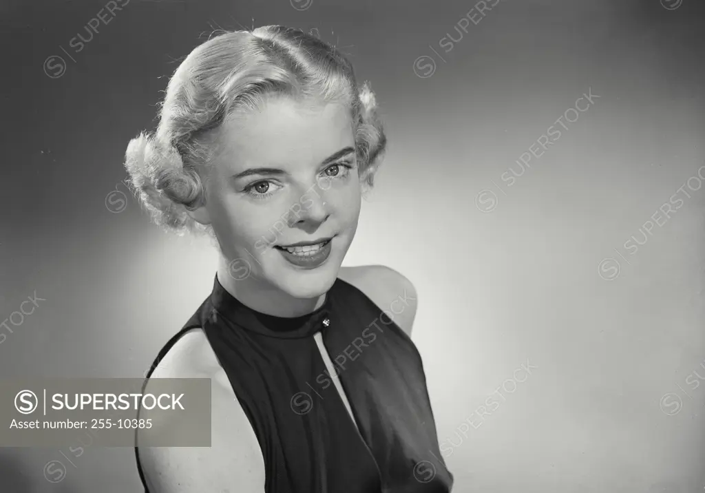 Vintage Photograph. Woman in sleeveless blouse smiling at camera