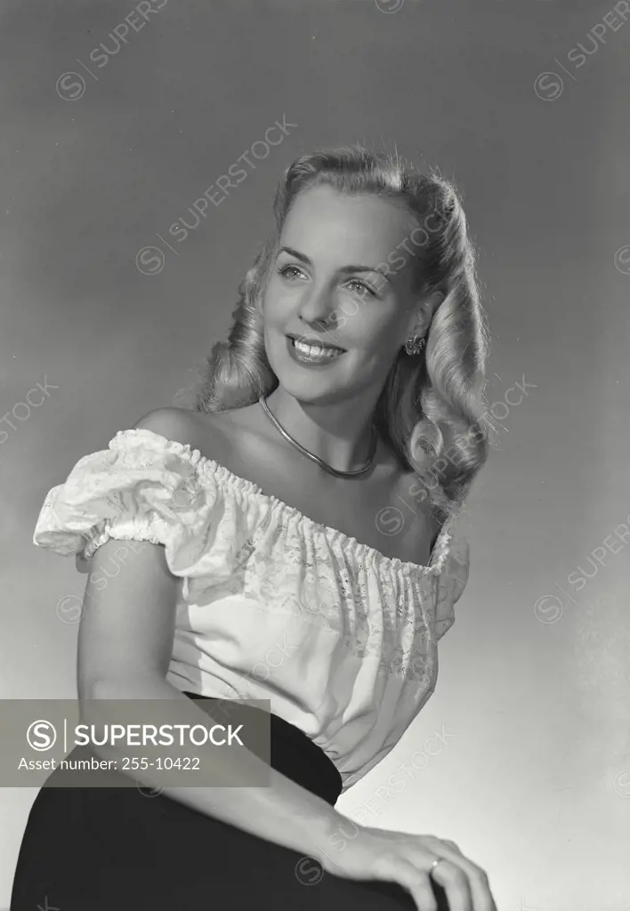 Vintage Photograph. Model in lace blouse leaning back and smiling off camera