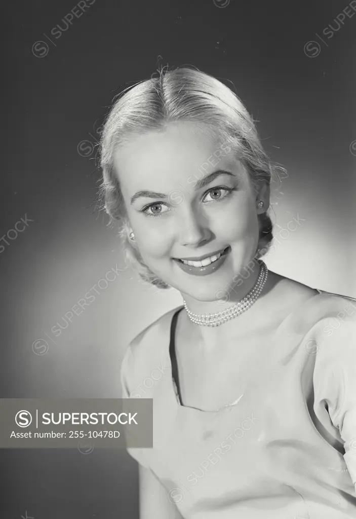 Vintage Photograph. Young woman in dress smiling with teeth