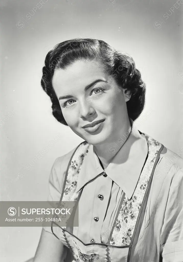 Vintage Photograph. Happy brunette woman wearing apron over blouse