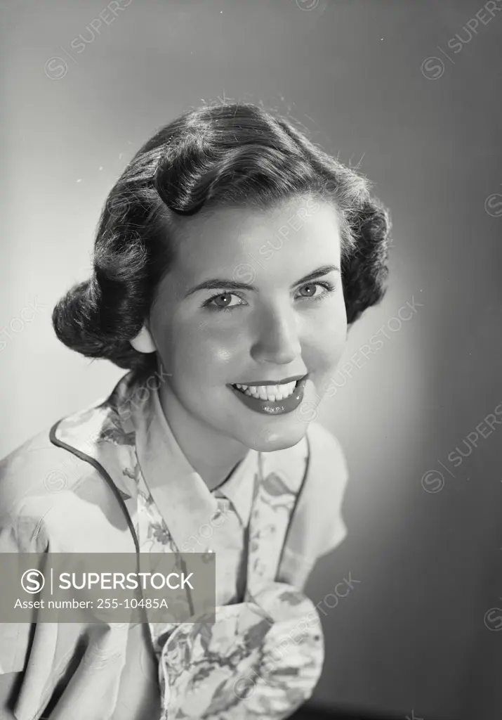 Vintage Photograph. Smiling brunette woman with curled hair wearing apron over blouse