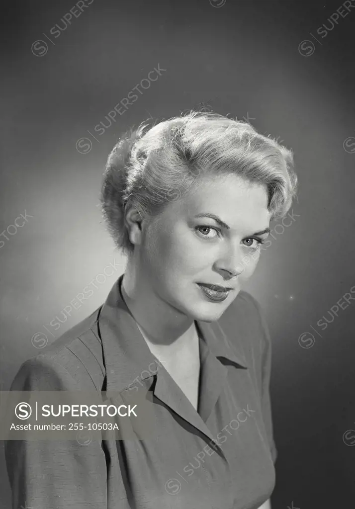Vintage photograph. Portrait of woman with blonde hair turned slightly to one side