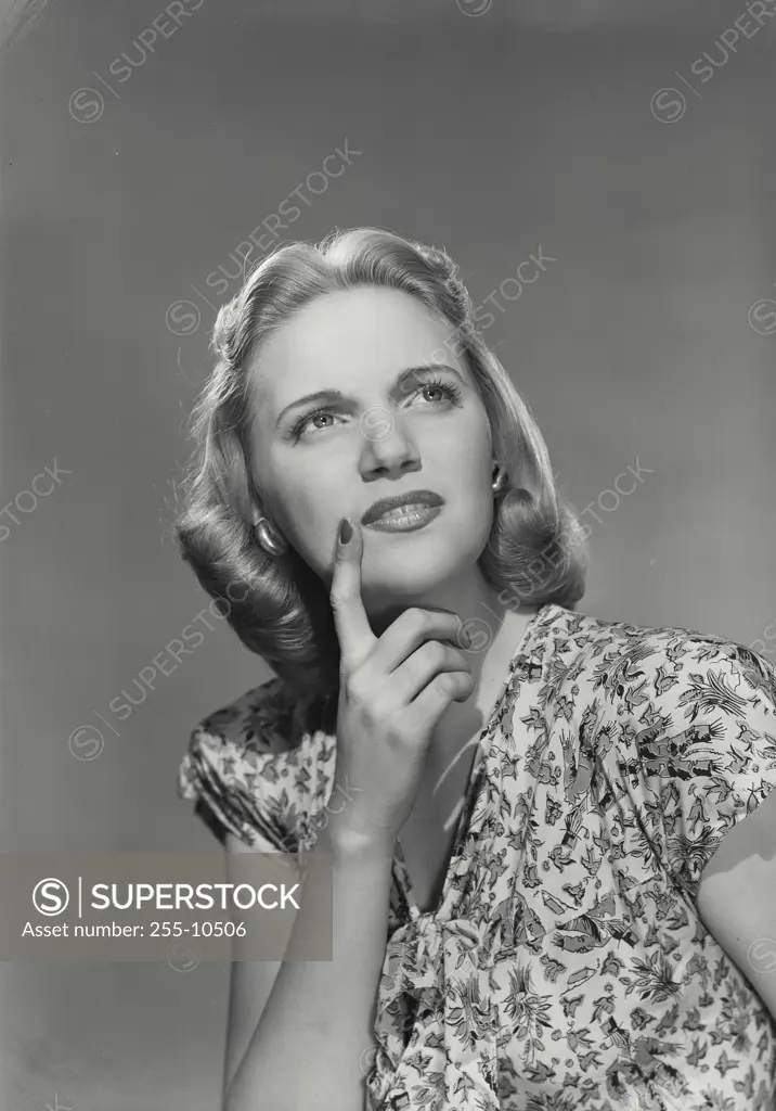 Vintage photograph. Close-up of a young woman with hand on chin thinking