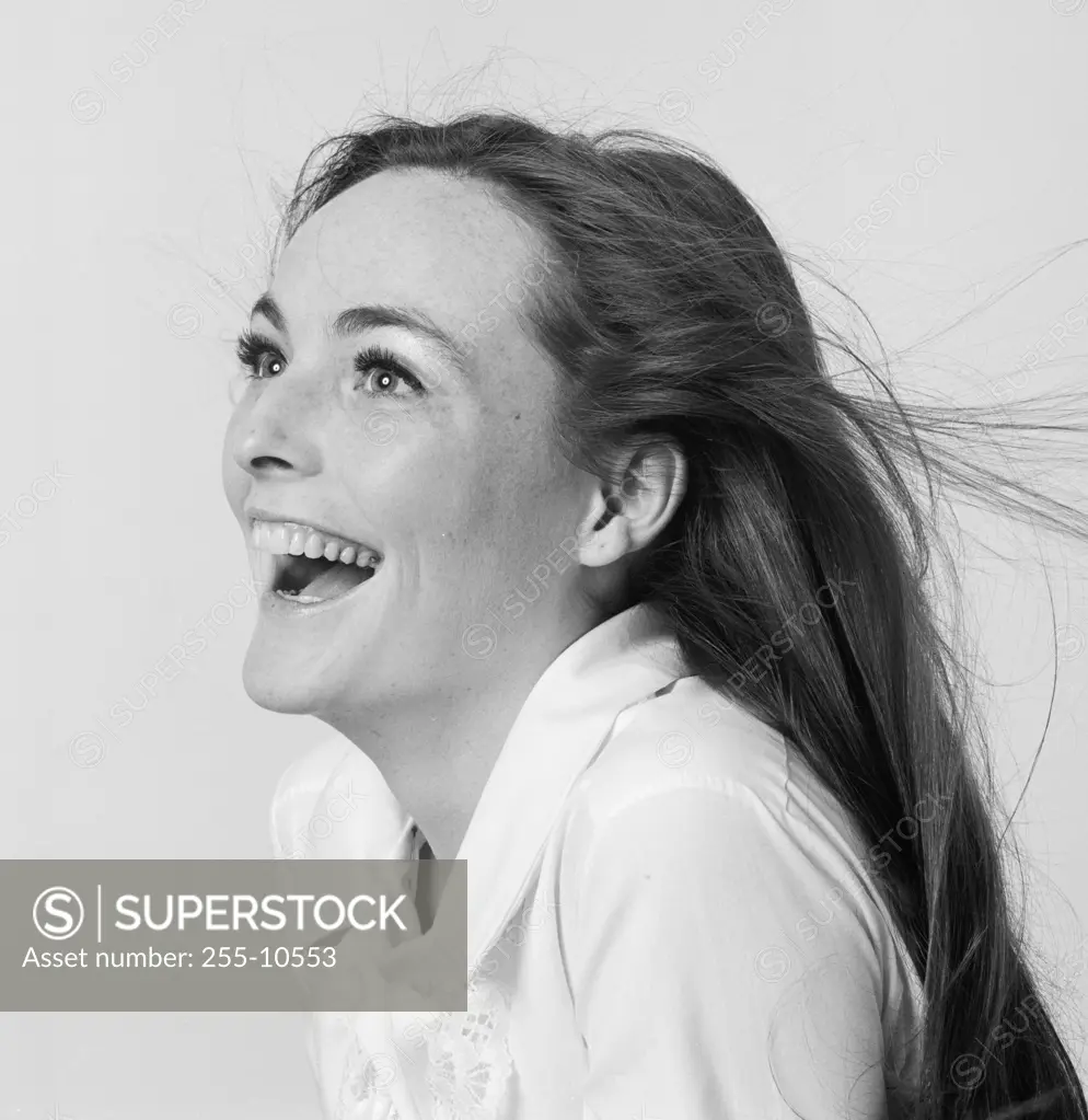 Side profile of a young woman laughing