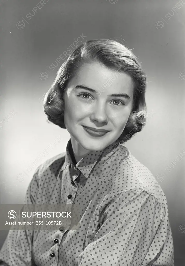 Portrait of young woman wearing polka dotted blouse