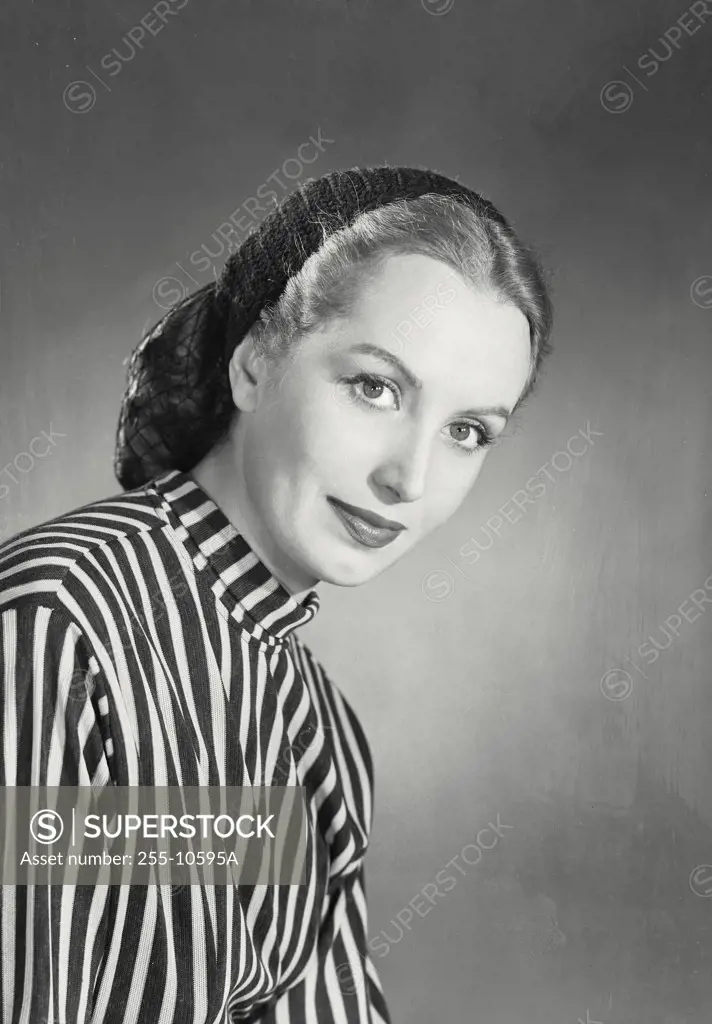 Blonde woman wearing striped blouse and knit cap with snood