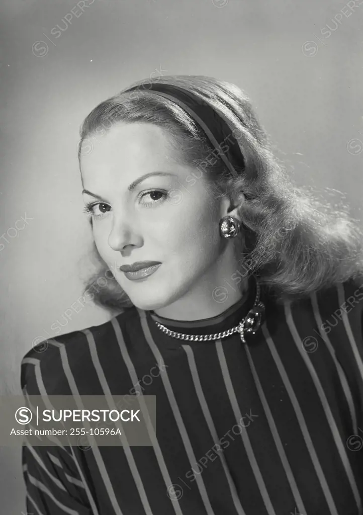 Vintage Photograph. Woman wearing vertically striped dark blouse looking at camera