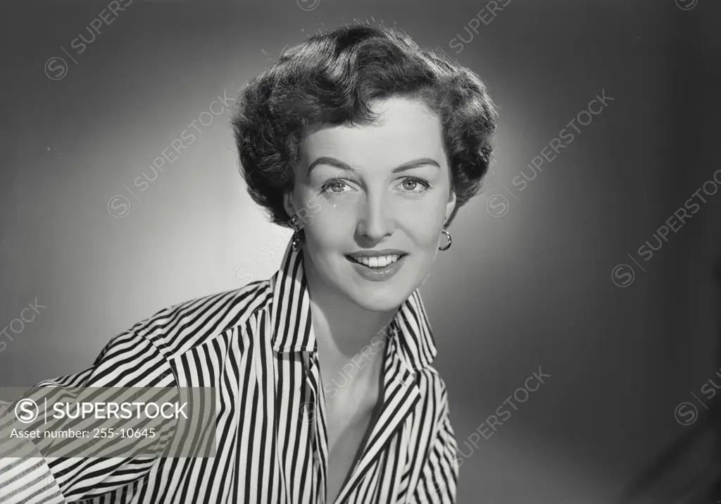 Vintage Photograph. Woman in striped button shirt smiling at camera.