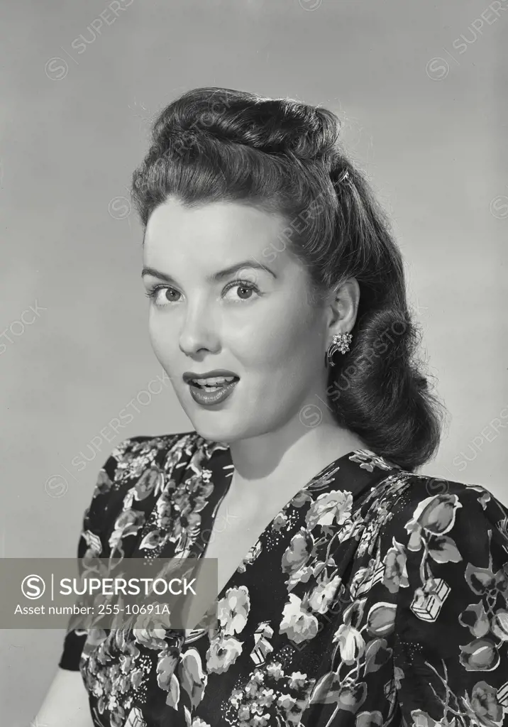 Vintage Photograph. Woman in floral shirt smiling at camera