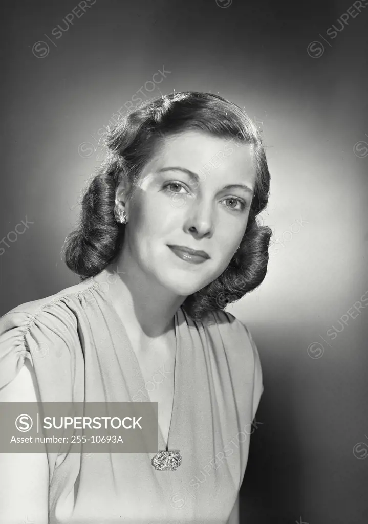 Vintage Photograph. Woman with curled hair wearing V-neck blouse with brooch