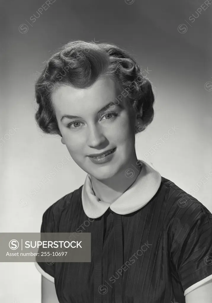 Vintage Photograph. Woman in collared shirt smiling at camera.