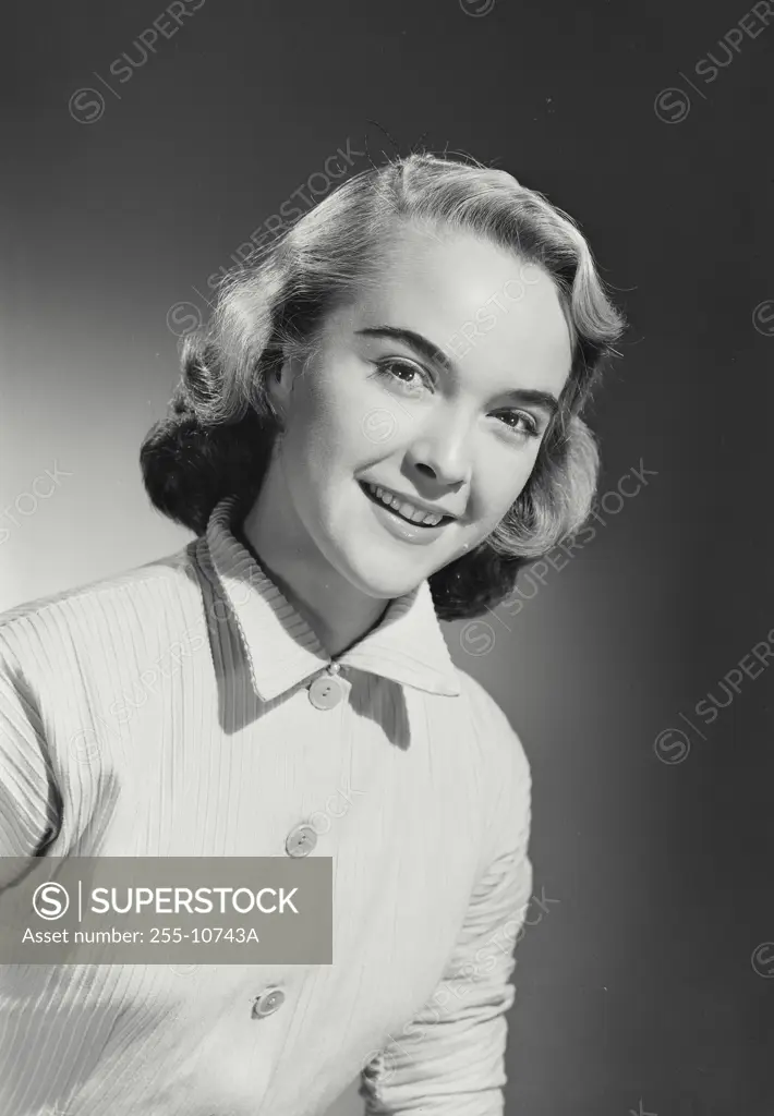 Vintage Photograph. Woman in button shirt smiling at camera with head tilted