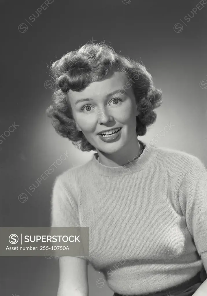 Vintage photograph. Portrait of woman in sweater smiling.