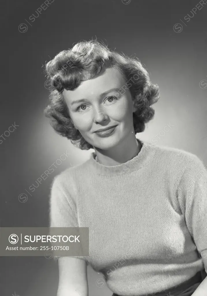 Vintage photograph. Portrait of woman in sweater smiling.
