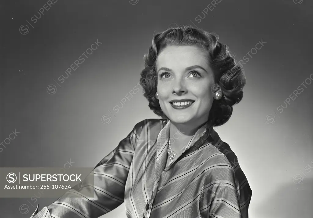 Vintage Photograph. Woman in silk button blouse smiling above camera