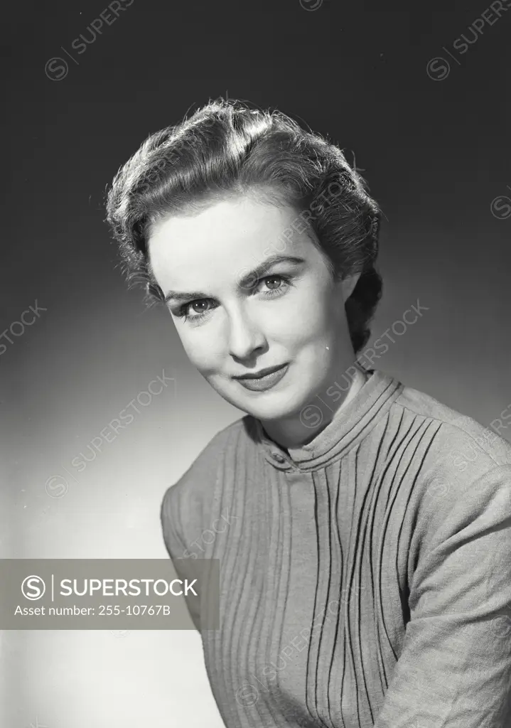 Vintage Photograph. Woman in layered button shirt smirking at camera