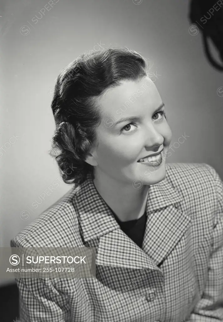 Vintage photograph. Brunette woman smiling wearing gingham plaid pattern jacket