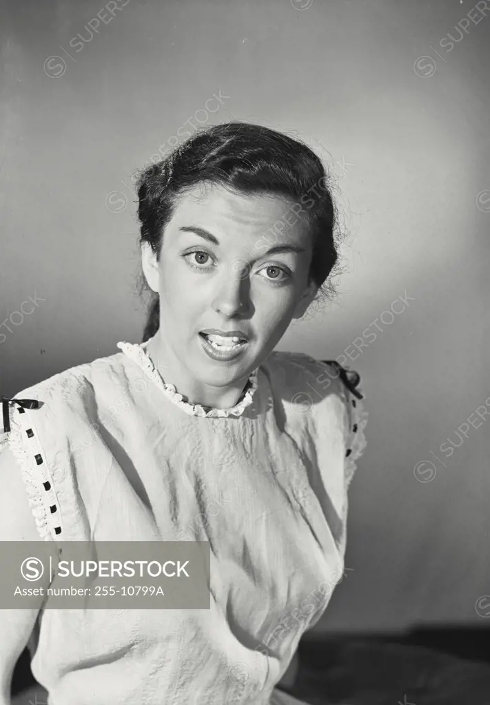 Vintage photograph. Portrait of a young brunette woman looking surprised
