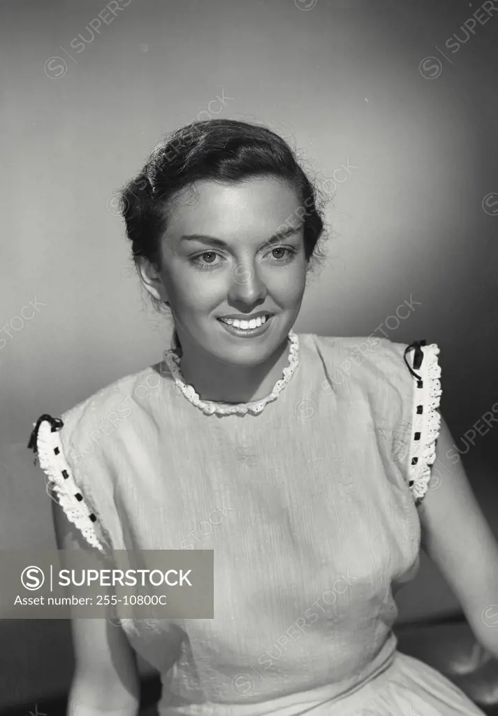 Vintage photograph. Close-up of a young brunette woman smiling