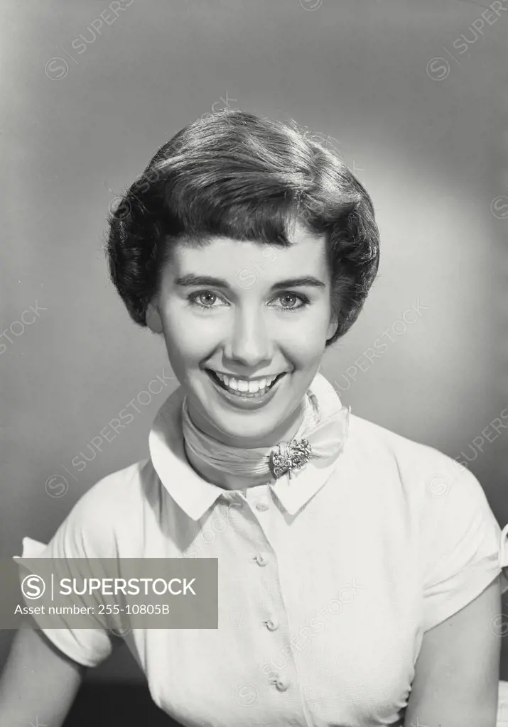 Vintage photograph. Portrait of brunette woman smiling wearing ribbon neck scarf