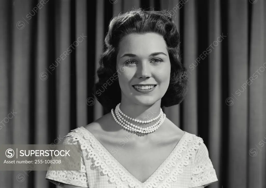 Vintage Photograph. Woman in dress and pearls smiling at camera. Frame 3